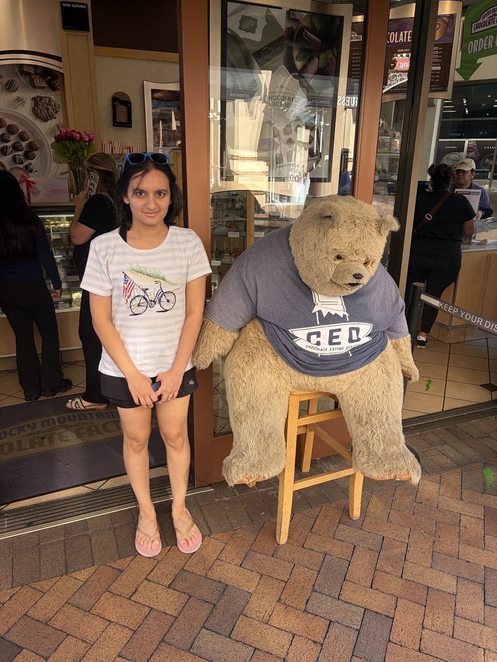 An organizer beside a giant teddy bear