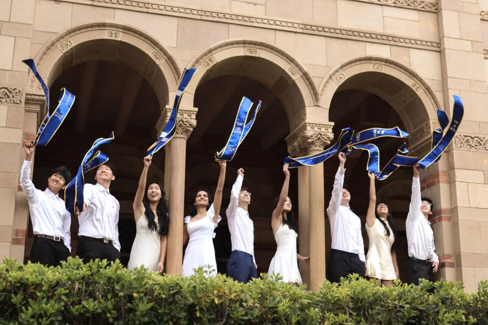 Graduating organizers throwing their caps at Royce Hall
