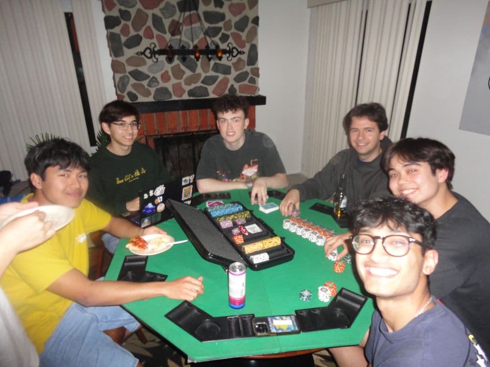 Organizers around a poker table on a games night