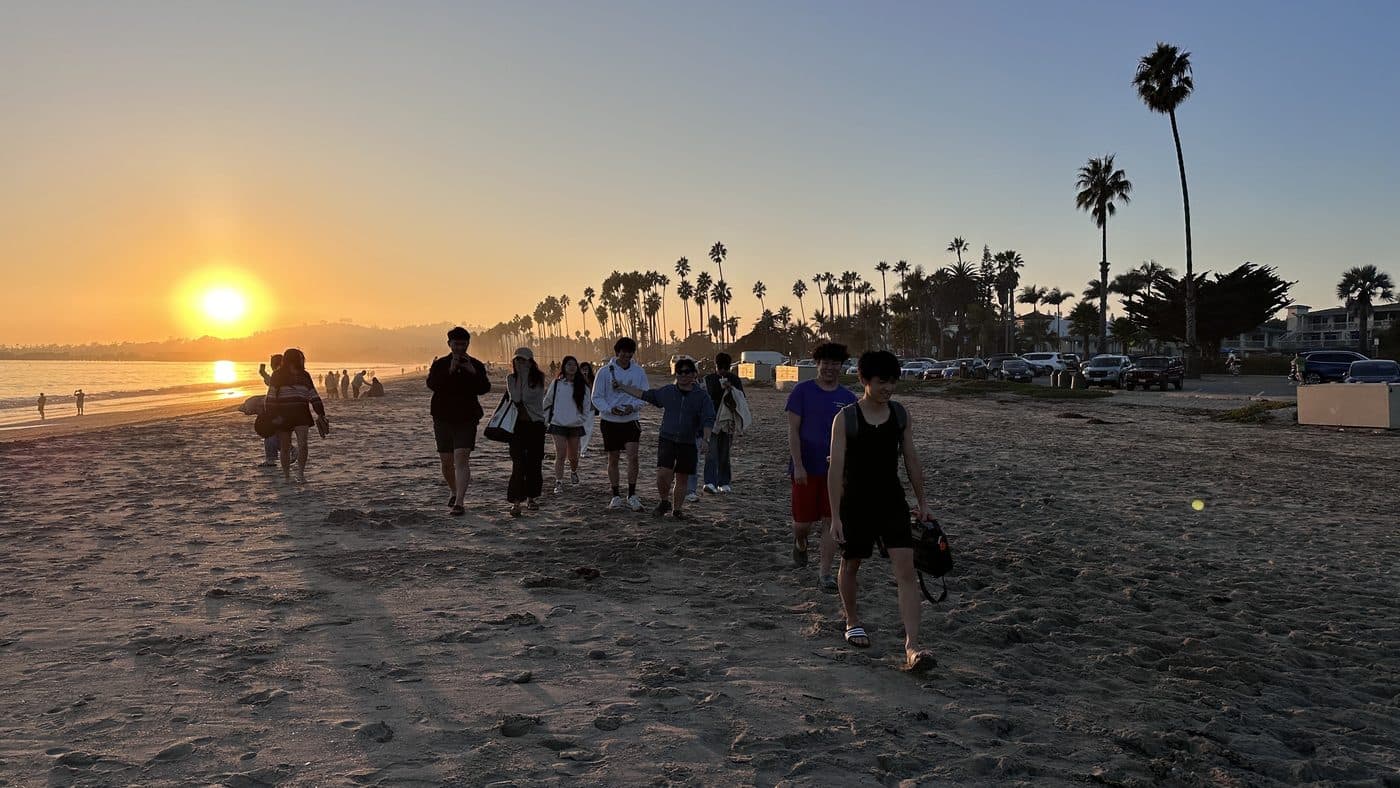 LA Hacks organizers walking on the beach at sunset