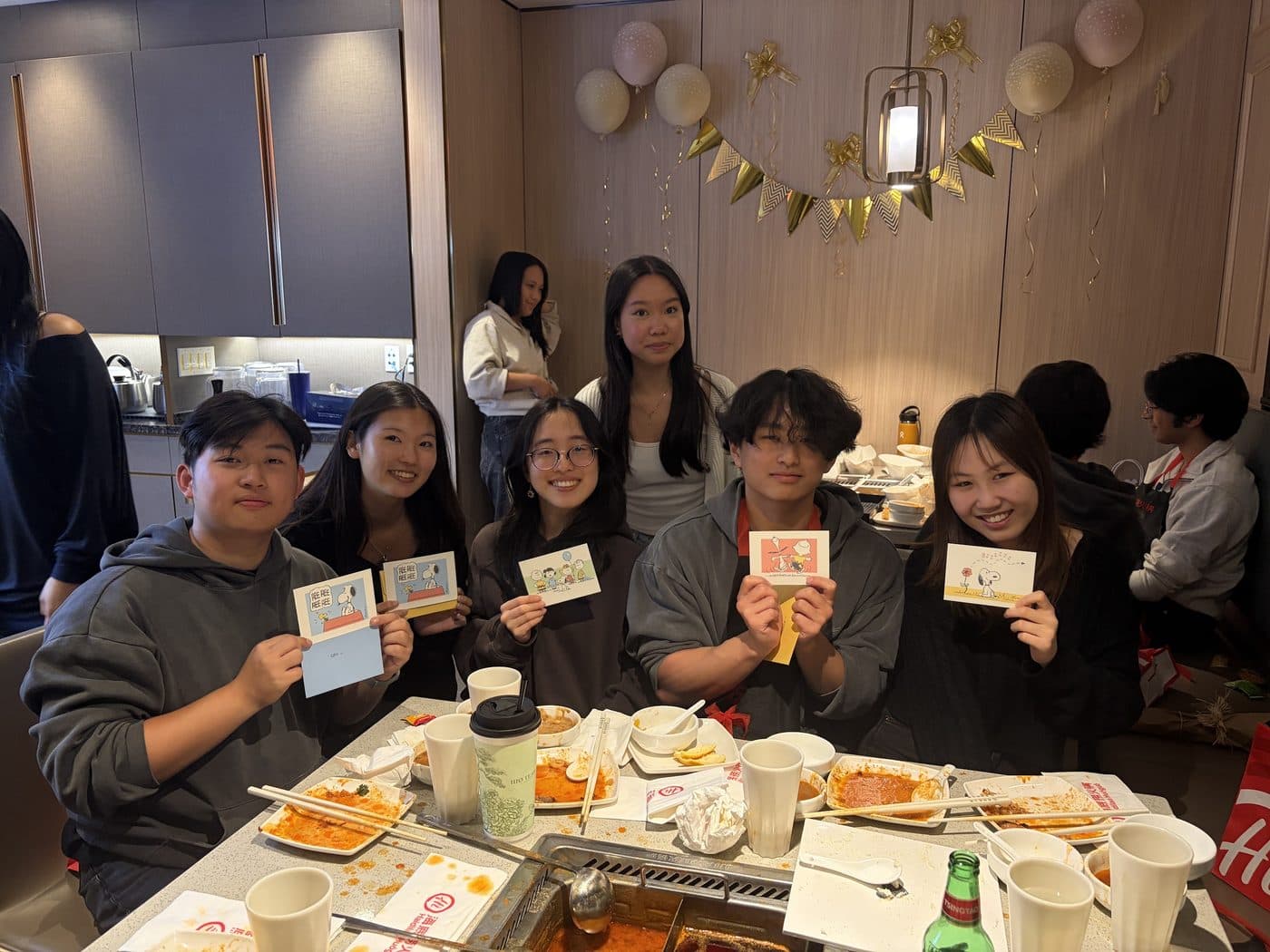 LA Hacks organizers at a team dinner holding gifts