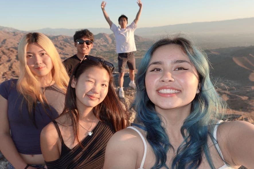 Five LA Hacks organizers taking a selfie on the beach